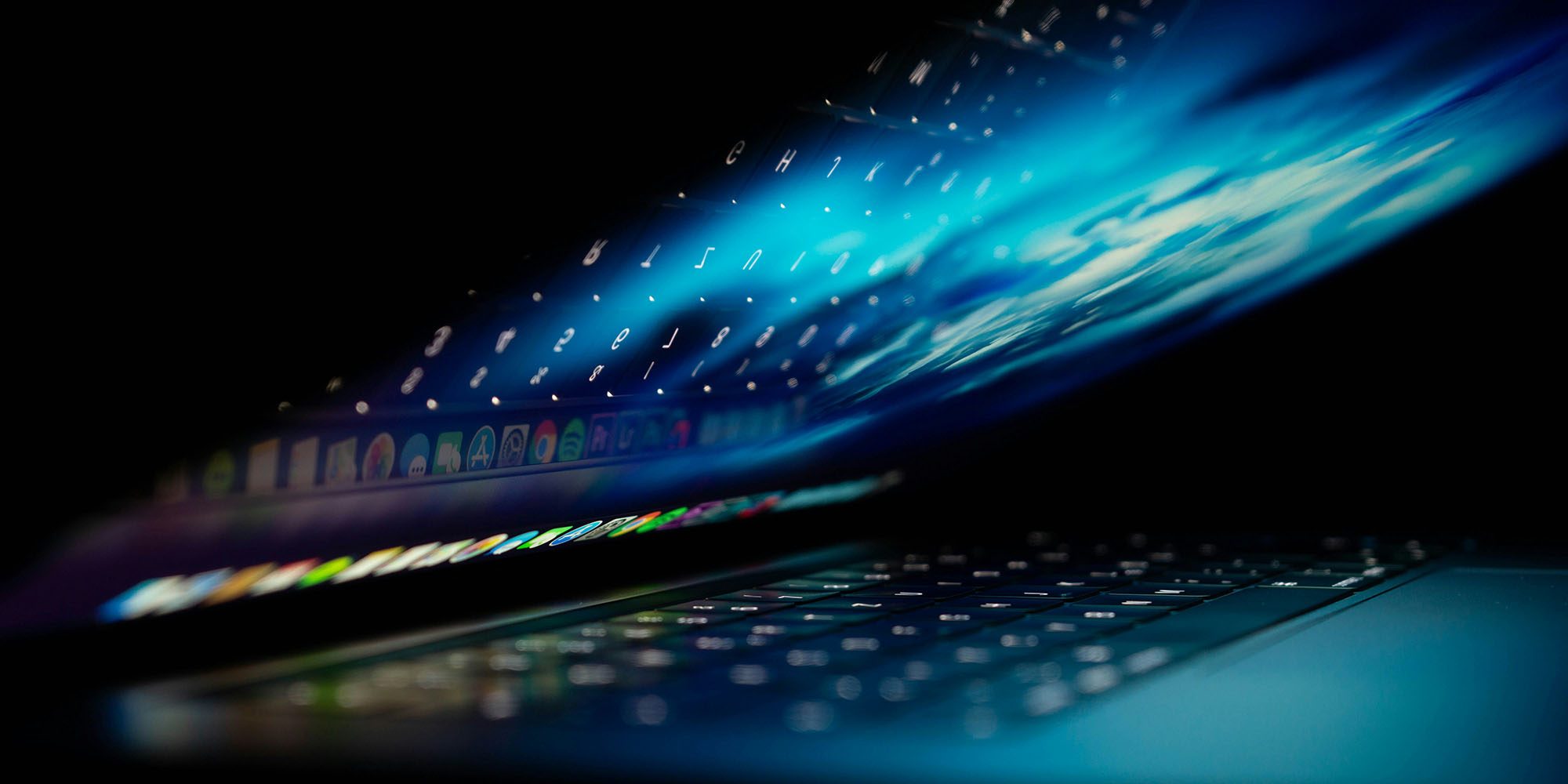 Beware of fake Mac crash reports | Image shows a partially open MacBook with abstract blue graphics